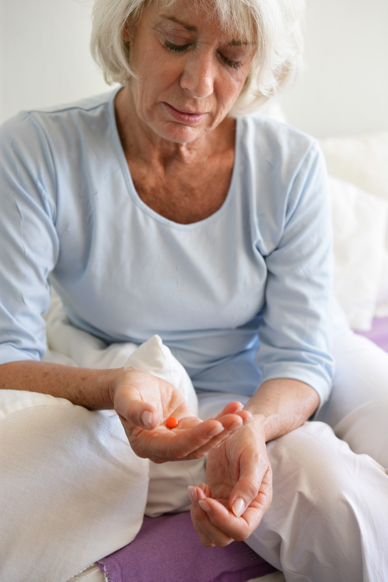 Elderly woman taking a pill