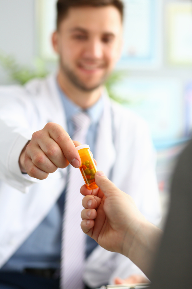 Doctor holds capsules like gabapentin in his hand